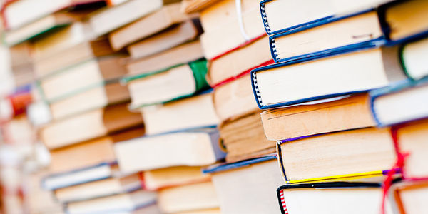 Photo of a wall of books with their pages facing out