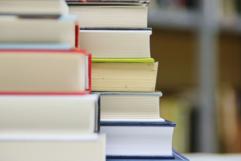 Photo of piles of books with their pages facing out